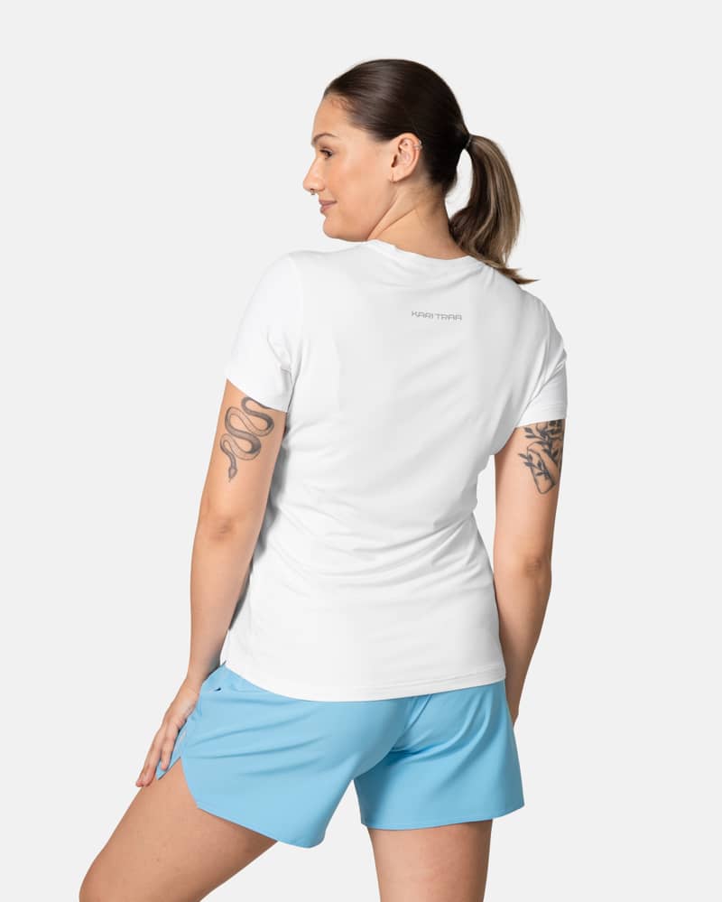 Back view of the white Kari Traa Ava Tee, showing its curved hem and smooth flatlock seams for comfort.