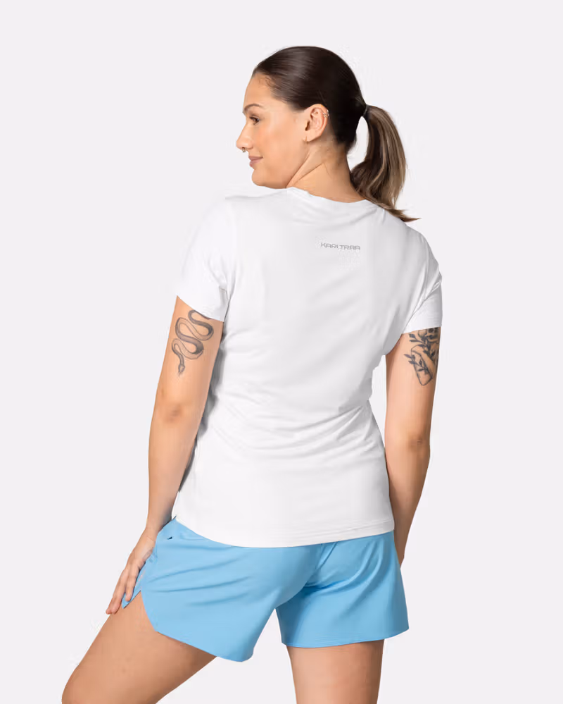Back view of the white Kari Traa Ava Tee, showing its curved hem and smooth flatlock seams for comfort.