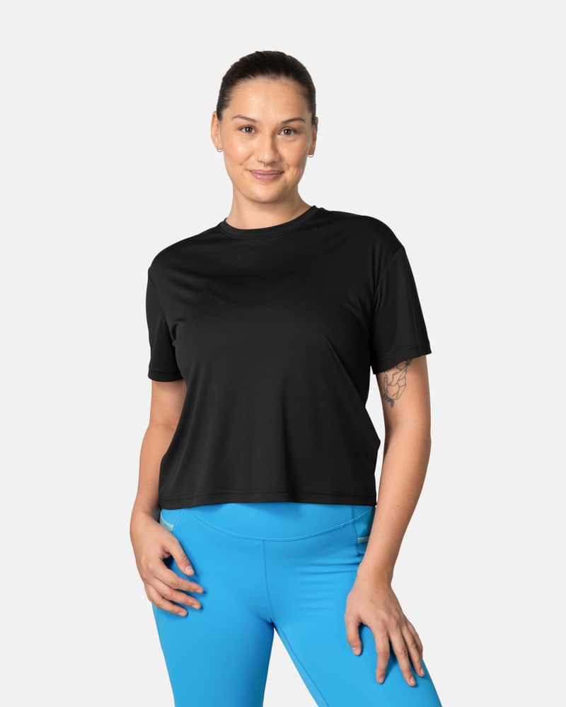 Woman wearing the Kari Traa Una Tee in black, a relaxed-fit shirt for workouts and warm weather adventures.