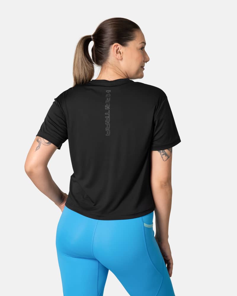 Back view of a woman in the black Kari Traa Una Tee, showing its relaxed fit for comfortable movement during workouts.
