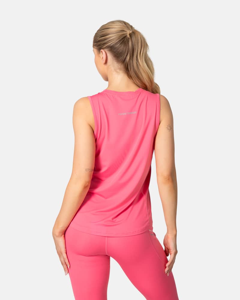 Back view of the pink Kari Traa Ava Tanktop showing the reflective logo and flattering curved hem for activewear.