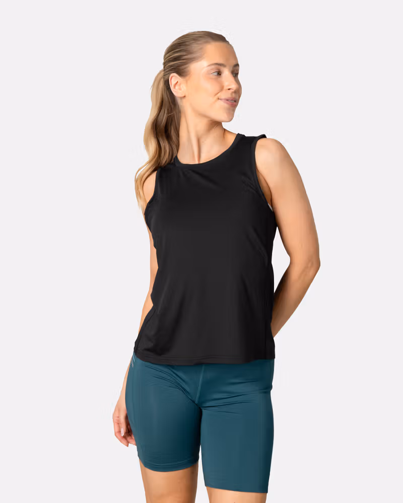 Woman wearing the black Kari Traa Ava Tanktop, showing its regular fit and round neck design for training.