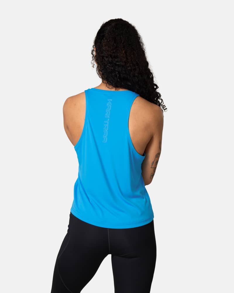 Back view of a woman in the blue Kari Traa Una Tanktop, showing the racerback design and vertical logo detail.
