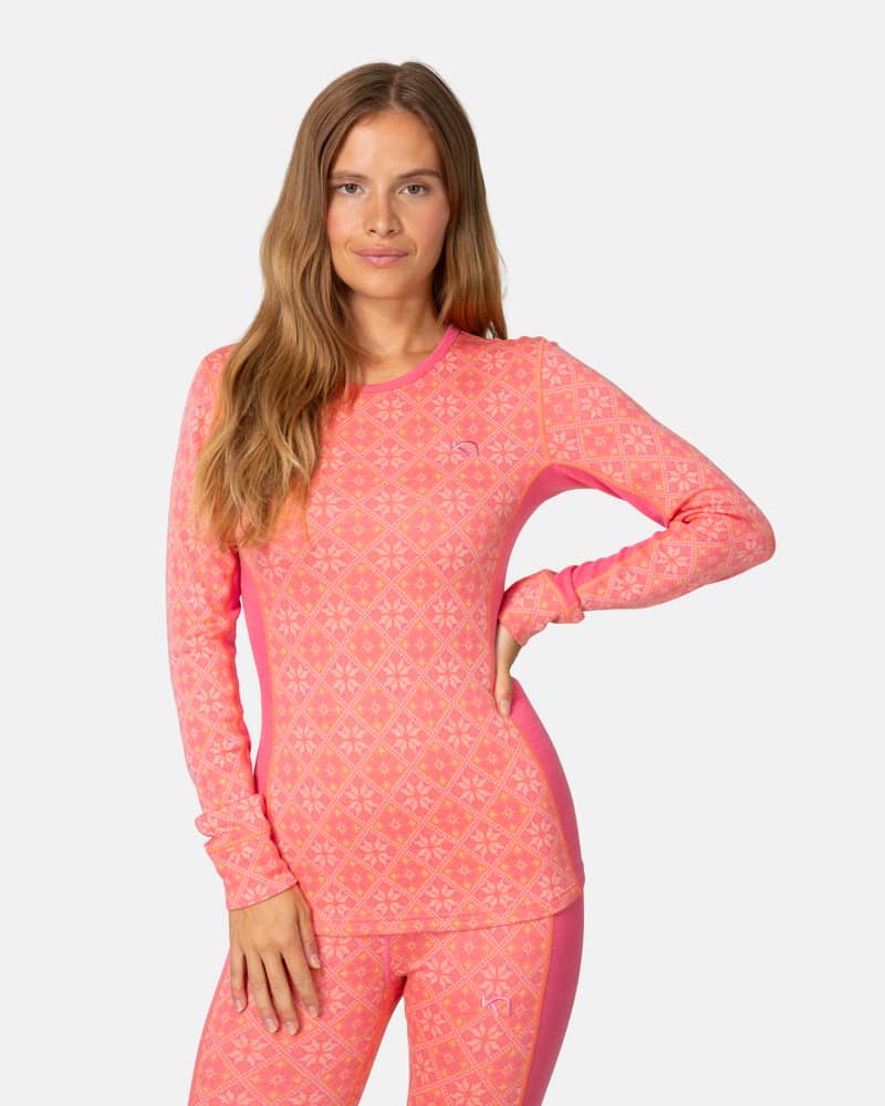 Woman wearing the pink Kari Traa Rose Long Sleeve 2.0, showing its comfortable and stylish design.