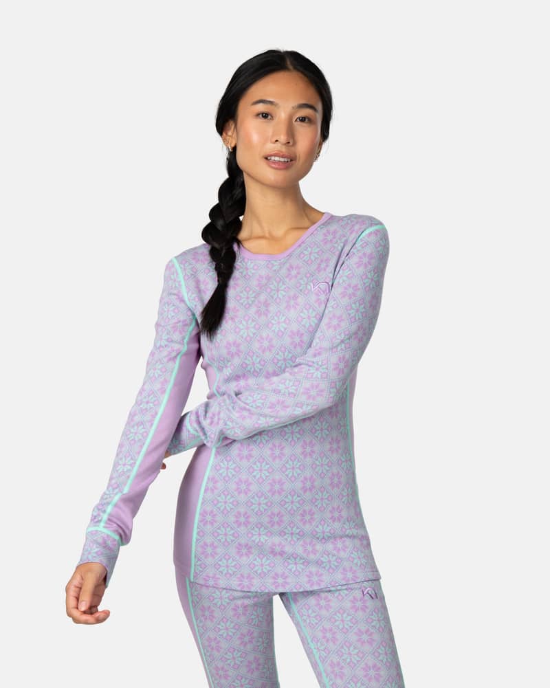 Side view of a woman in the lavender Kari Traa Rose Long Sleeve 2.0, showing the full length and design.