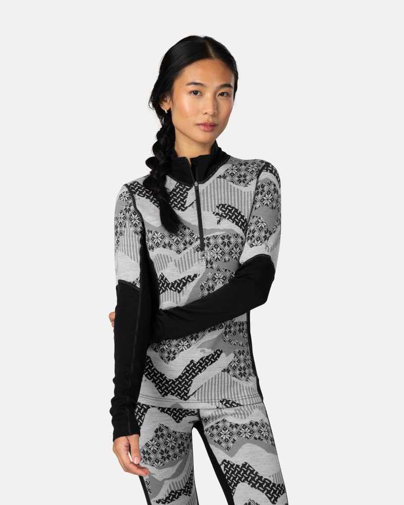 Woman wearing the black Kari Traa Olea Half Zip with a grey Nordic pattern, perfect for slopes-to-street style.