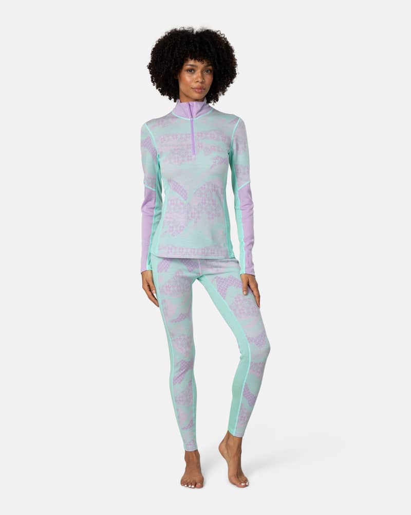Side view of a woman in the lavender Kari Traa Olea Half Zip, showcasing the high collar and half-zip neck.